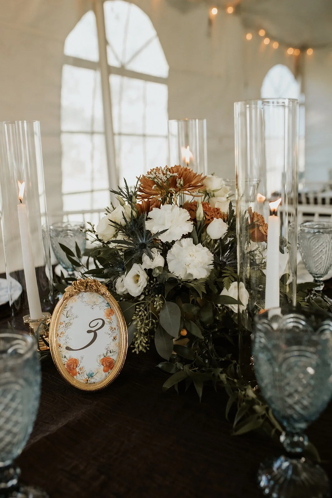 Custom wedding table number in vintage gold frame with autumn floral arrangement