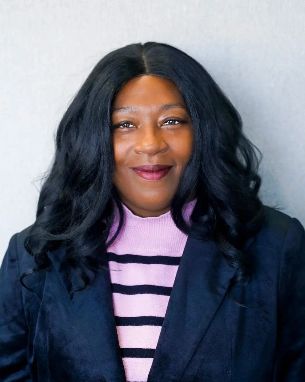 Person sitting on outdoor concrete steps, wearing glasses and a white top.