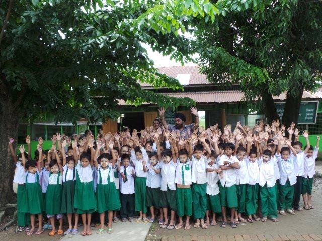 IMG.20-Mr.-Rikhi-with-the-Kids-raising-their-hands-2-1.jpg