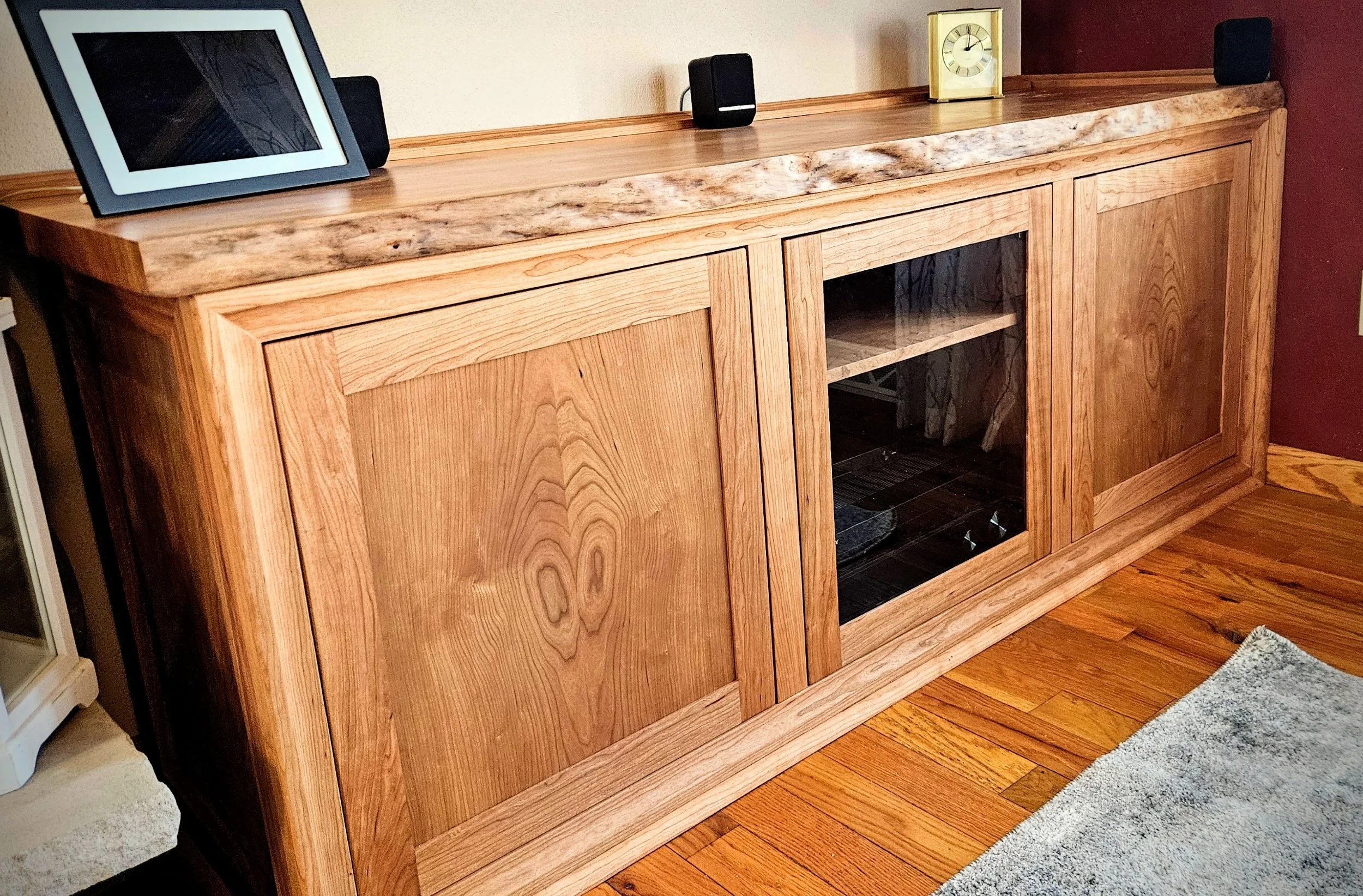Built in cherry entertainment cabinet with live edge top