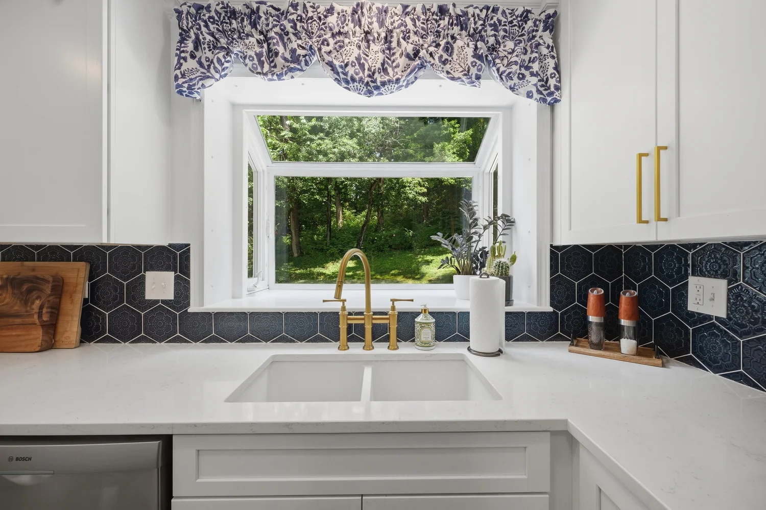 Kitchen sink with navy hex tile and a garden window