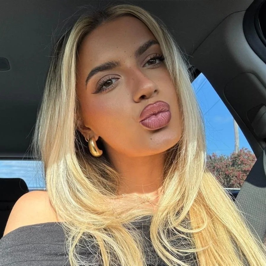 Young woman pouting show casing healed ombre lip tattoo