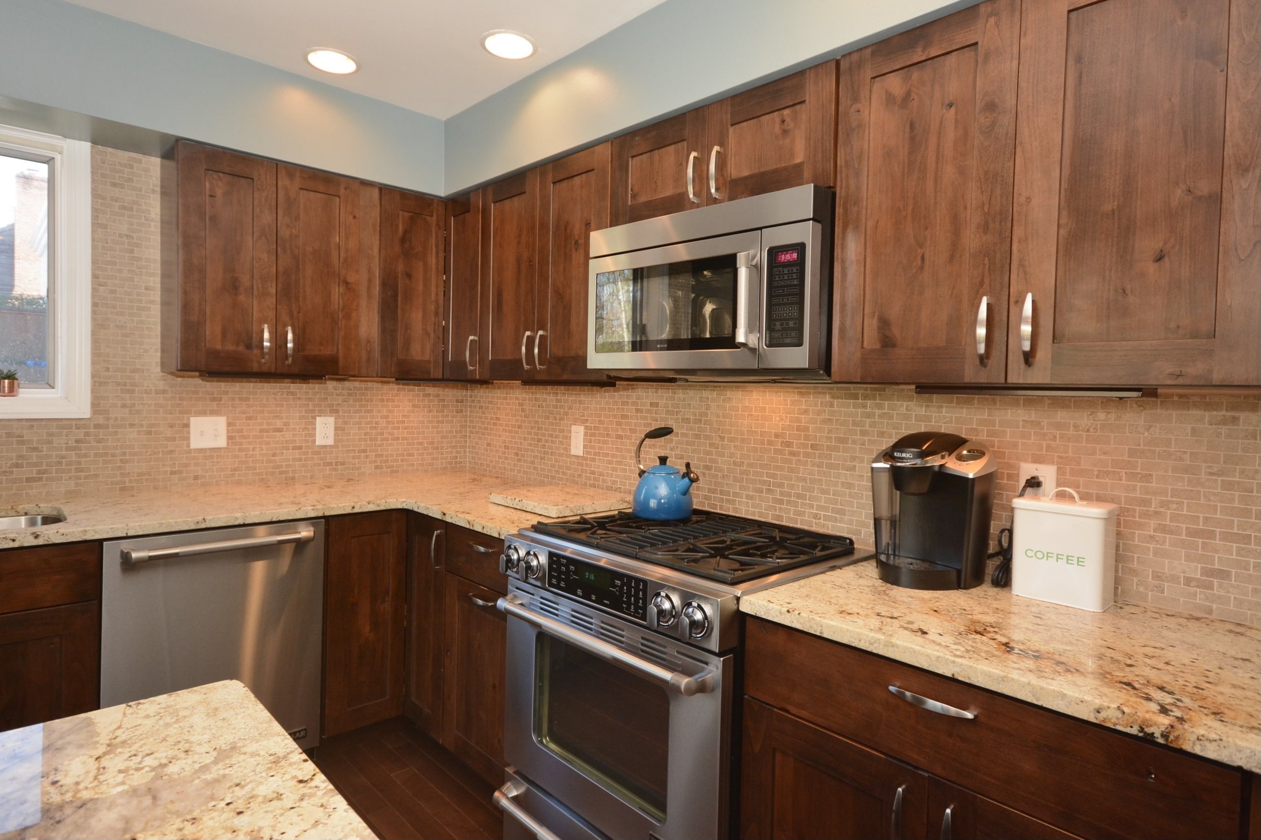 Solid Alder cabinetry installed with new backsplash. Drawer hardware installed. Under cabinet lighting installed.