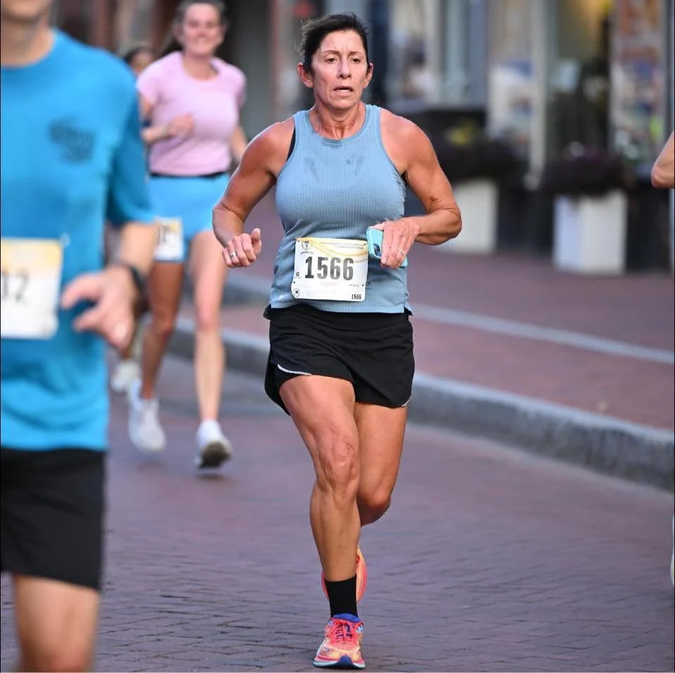 Woman running in road race
