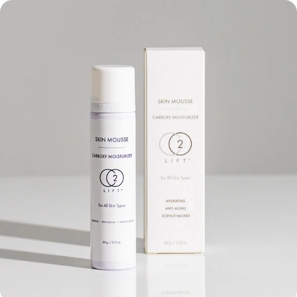 White bottle of CO2Lift skin mousse and its box packaging, labelled as Carboxy Moisturizer, for all skin types, with claims of hydrating and anti-aging benefits.