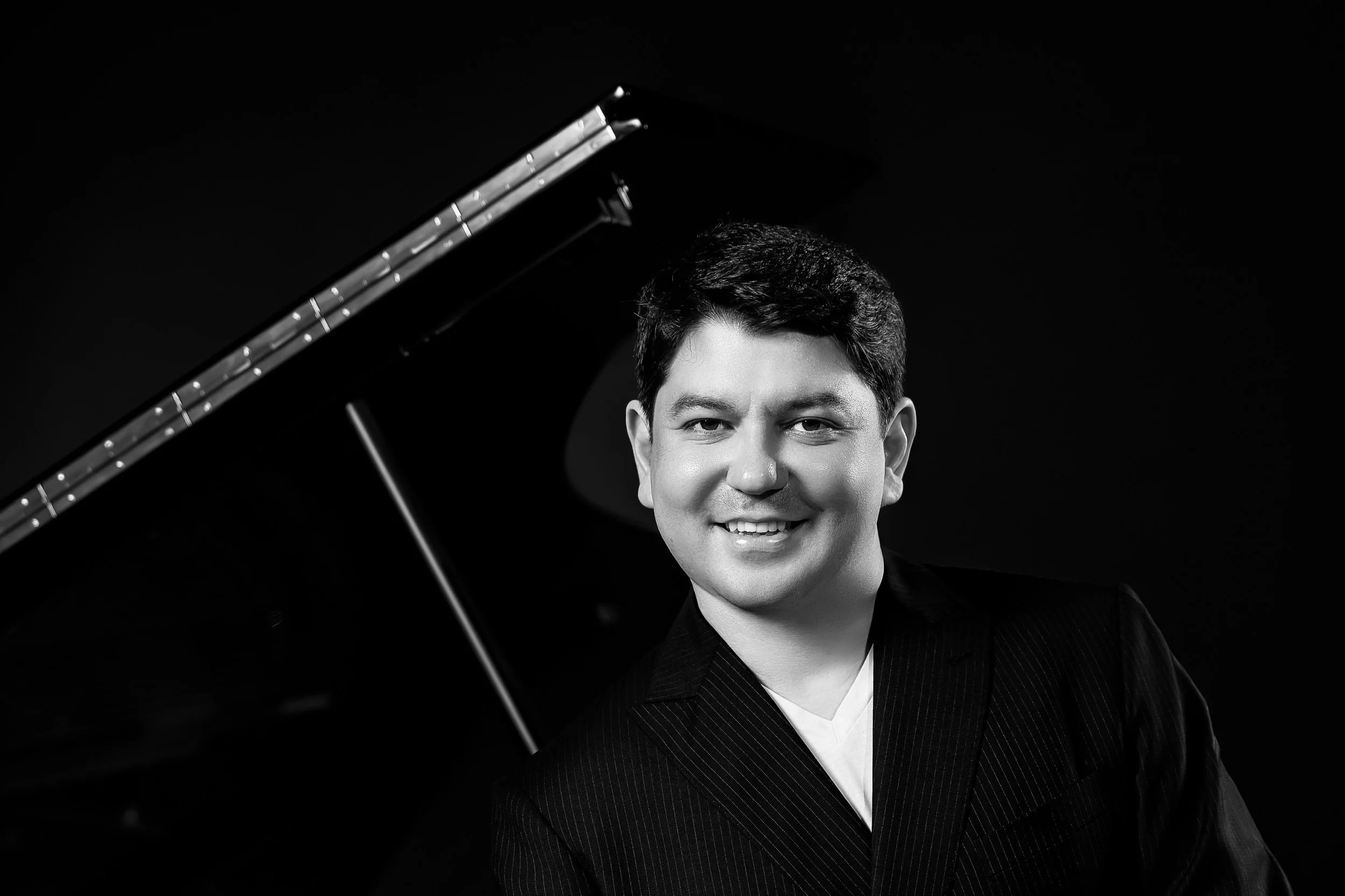 behzod-piano-standing-smile-bw-gallery.jpg