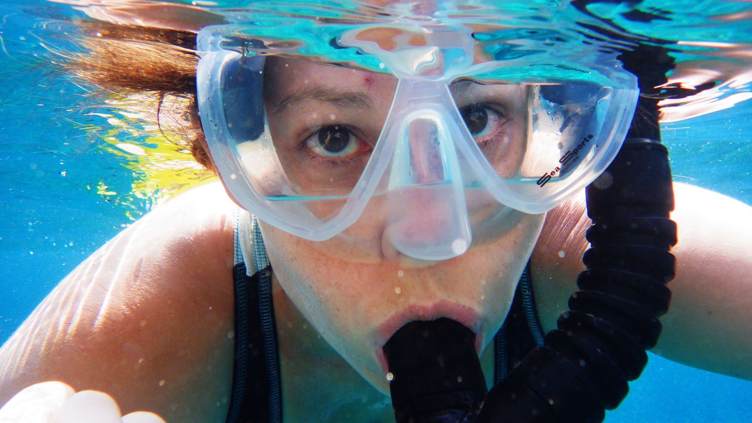 Person snorkeling underwater, illustrating the unfamiliar sensation of breathing through a mask that can feel similar to the adjustment some people experience when starting CPAP therapy.