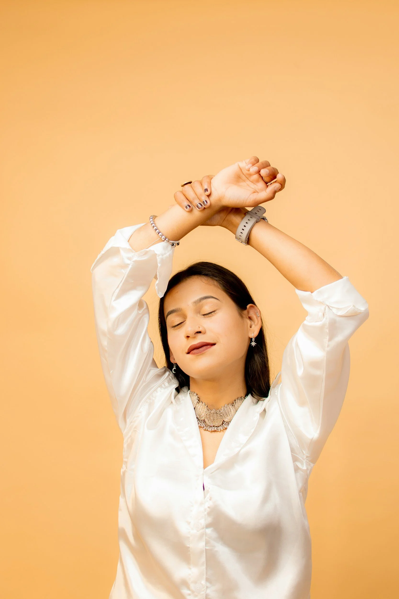 woman with arms stretched over head looking at peace | Small improvements in movement and comfort with chronic pain