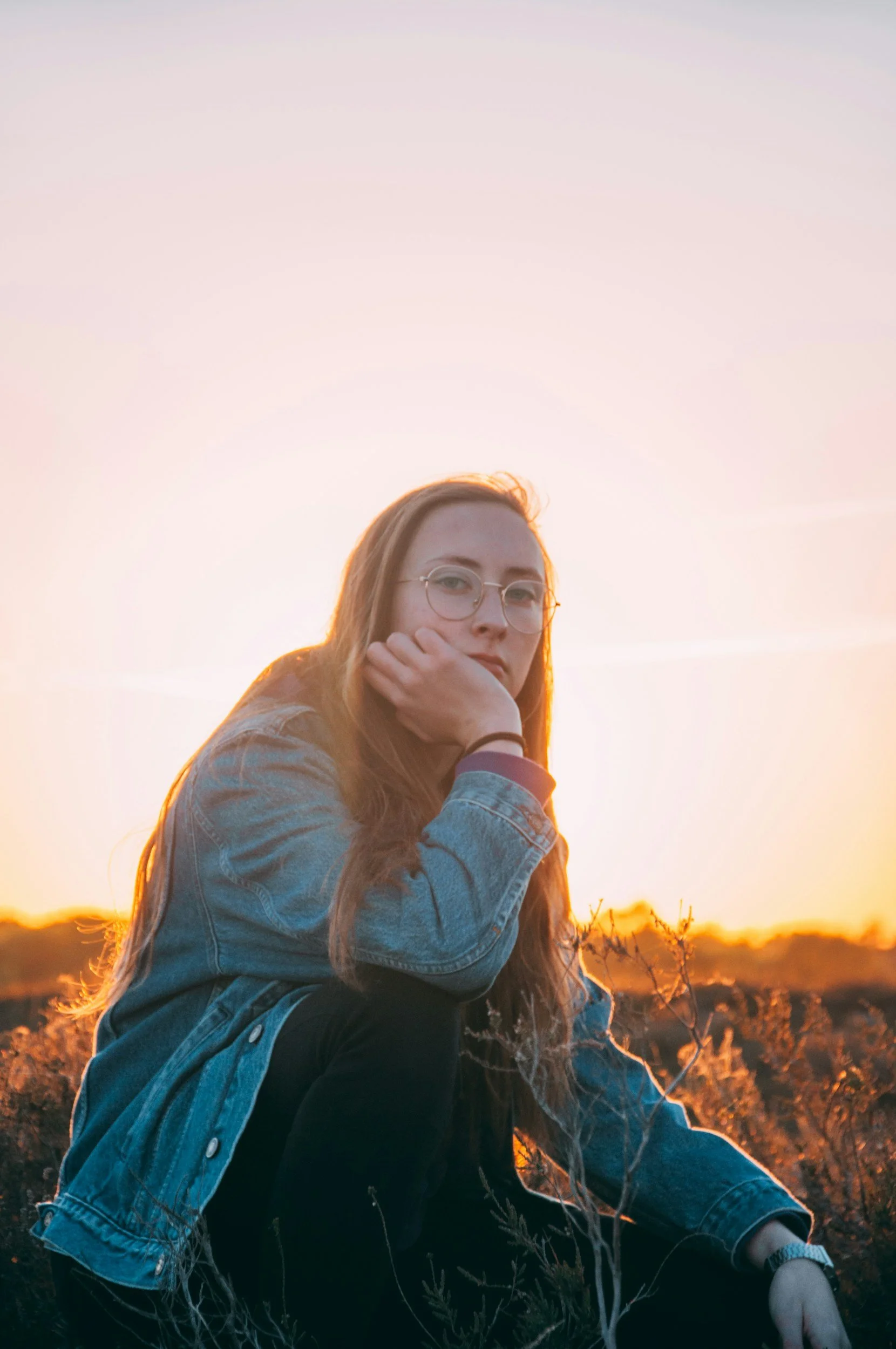 woman sitting and looking unsure | Feeling confused about chronic pain without a clear physical cause