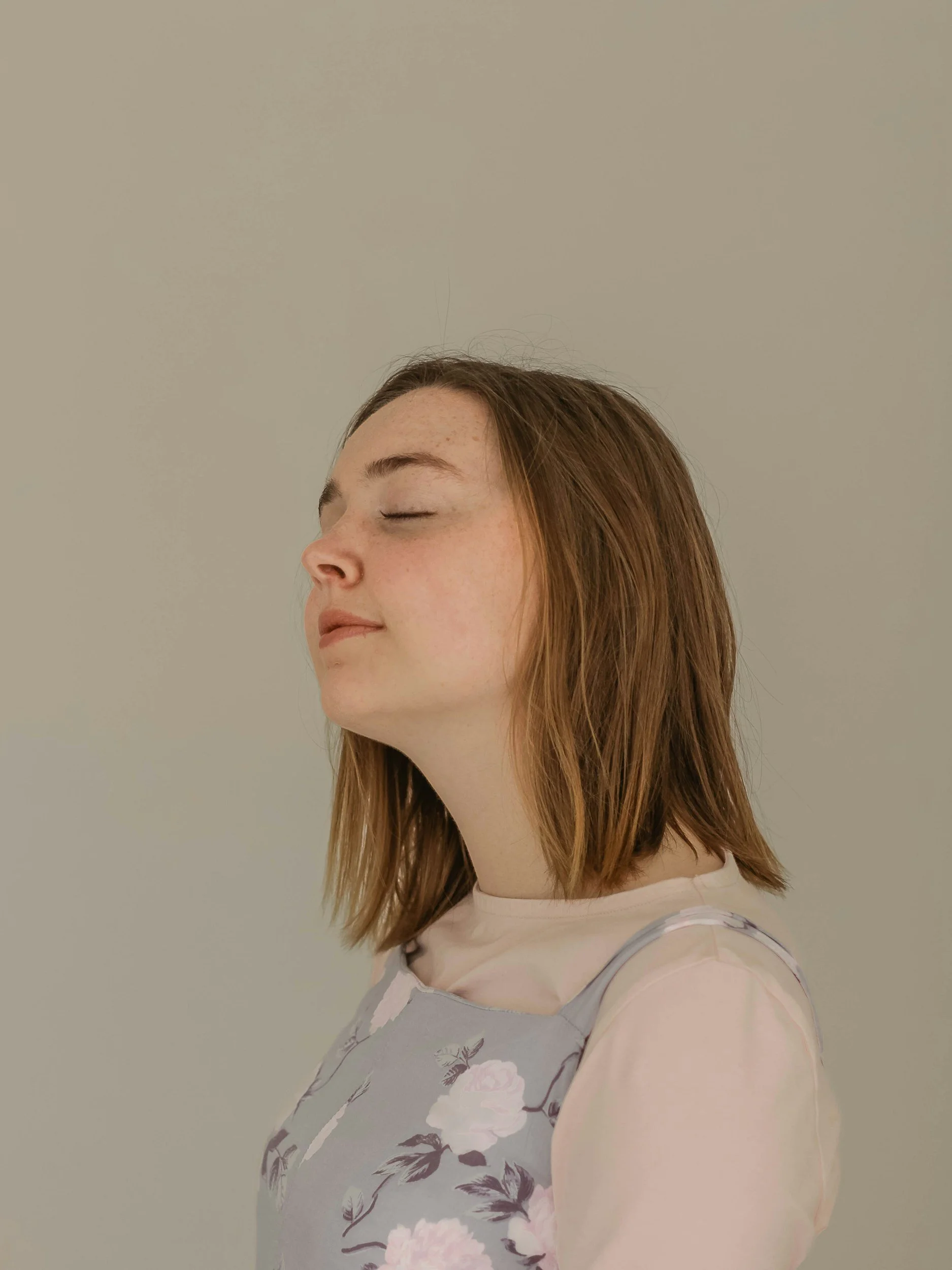 woman with eyes closed looking at peace | Calming the nervous system can help reduce chronic pain