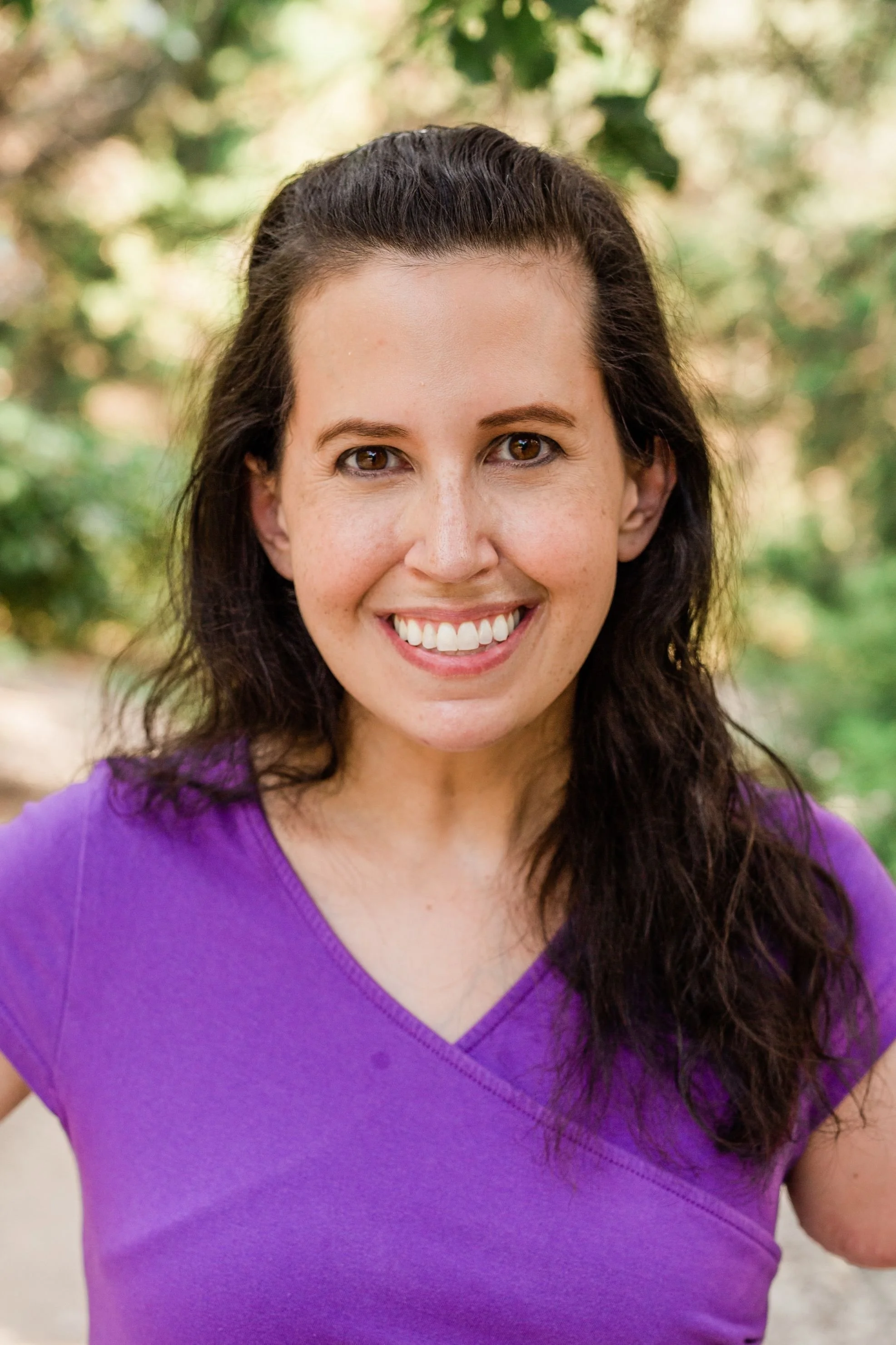 picture of Jessica Fink, LCSW-S | image of smiling woman with long brown hair in a purple stop standing outside