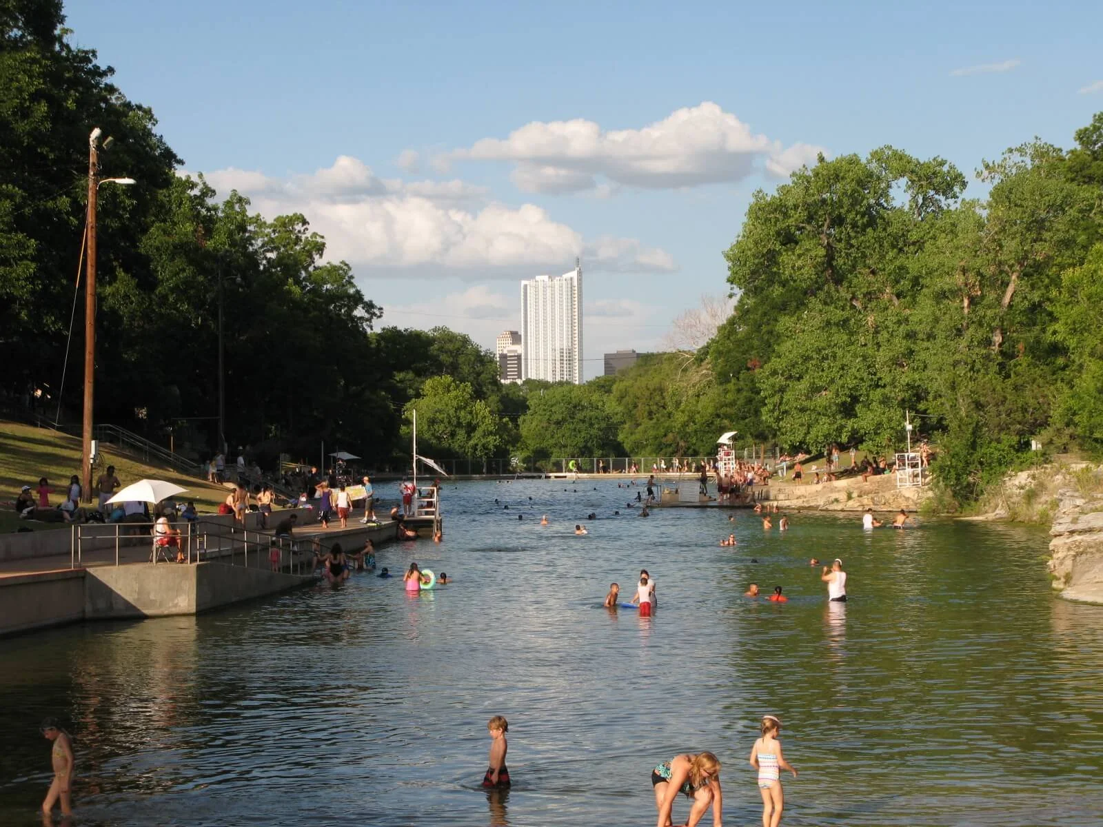 Barton Springs Pool in Austin, Texas, with people swimming in the spring-fed water, illustrating the gradual adjustment analogy used for adapting to CPAP therapy.