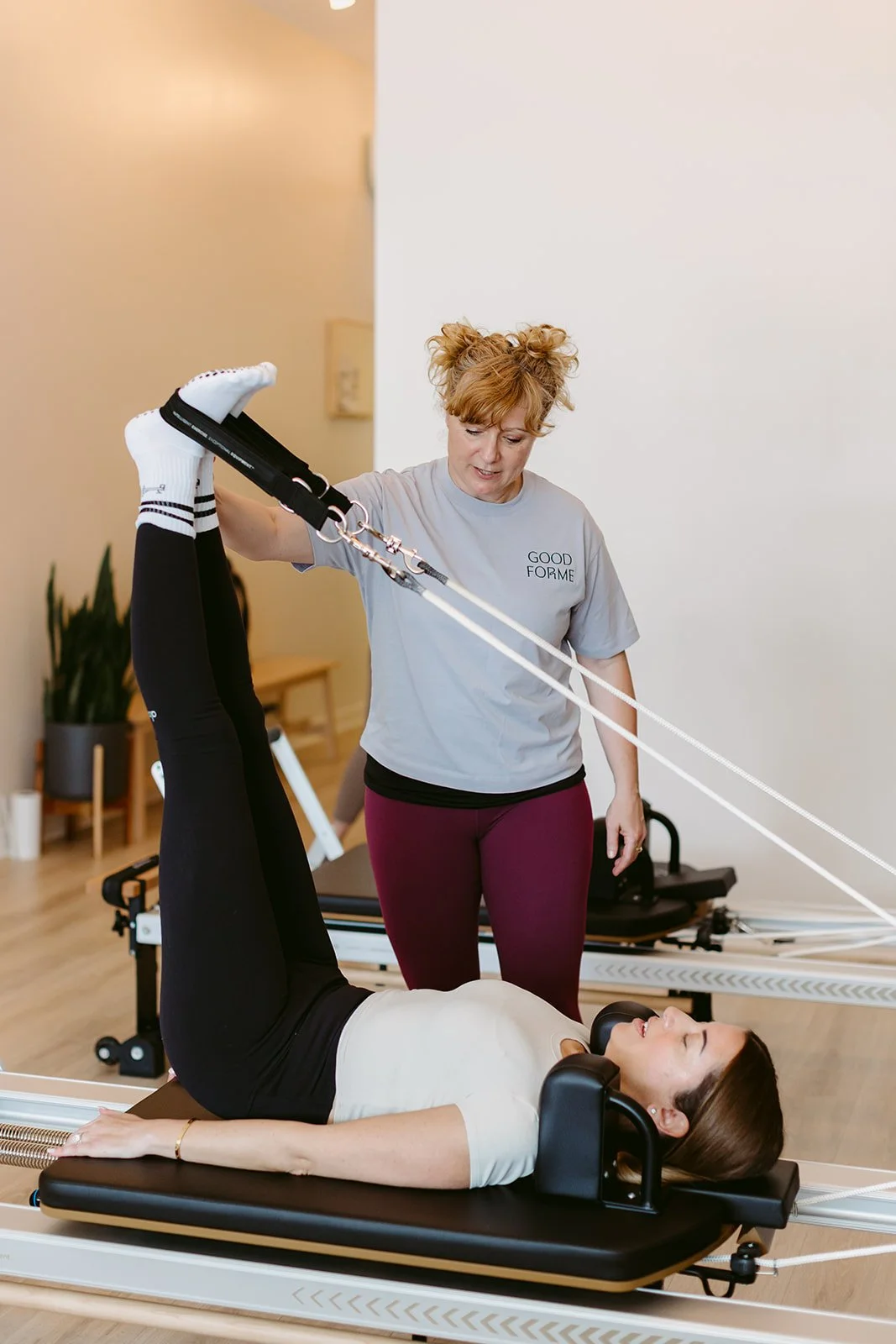 Reformer Pilates instructor teaching a private session