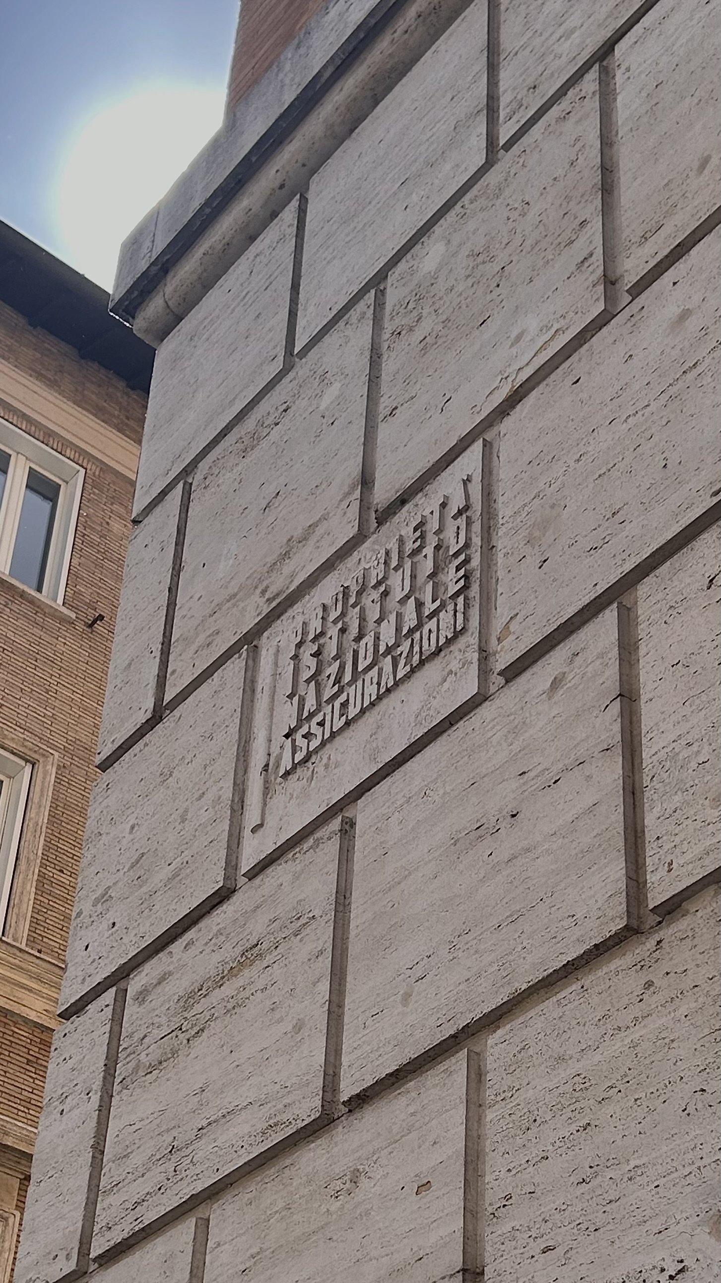 INA logo in Piazza Navona on a fascist-era building. Photographed by Audrey Huhn.