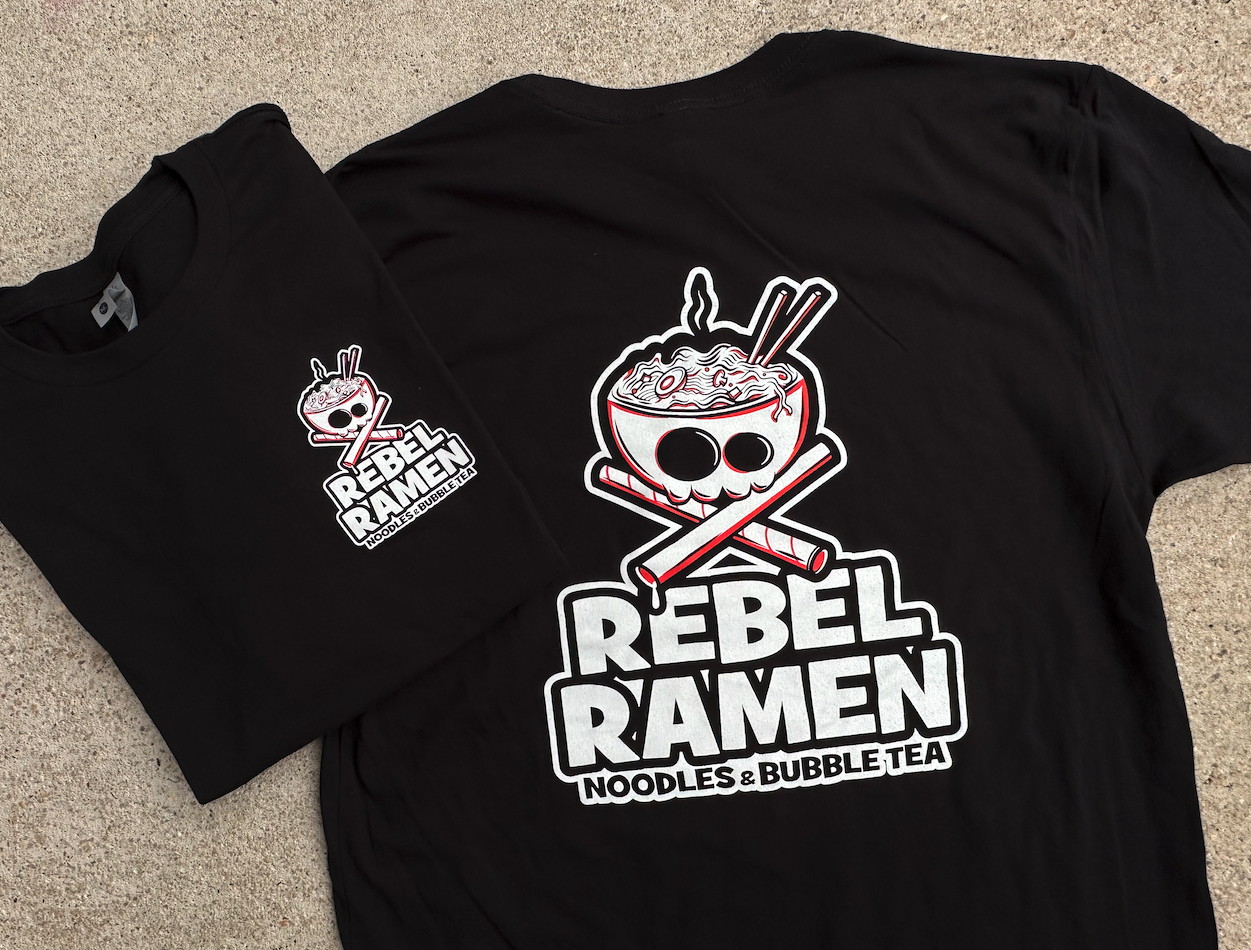 Two black t-shirts with a Rebel Ramen logo featuring a noodle bowl with chopsticks and the text "Rebel Ramen Noodles & Bubble Tea."