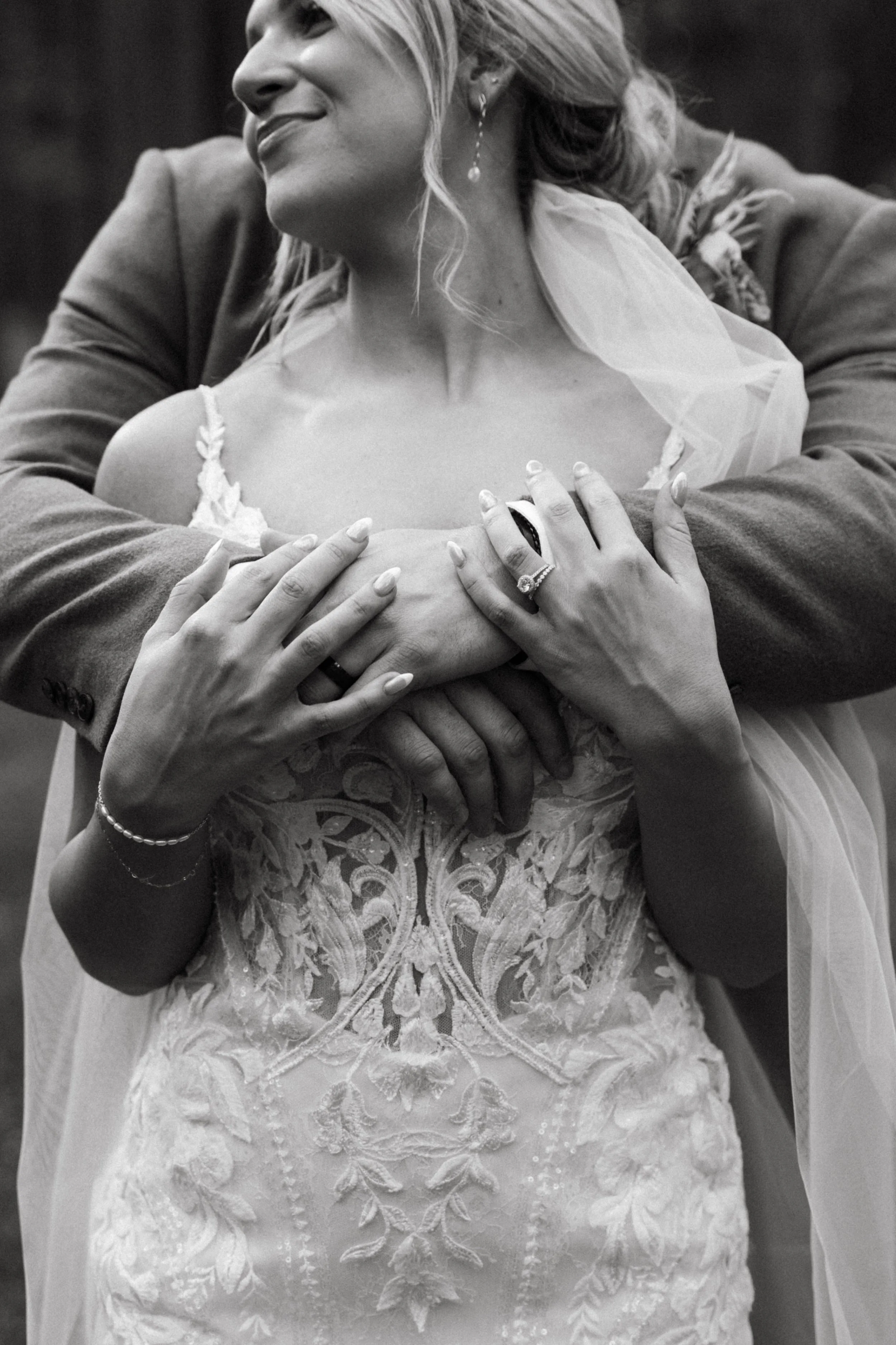 A wedding embrace with the bride's wedding ring shown prominently on her finger in Chatham, Ontario.