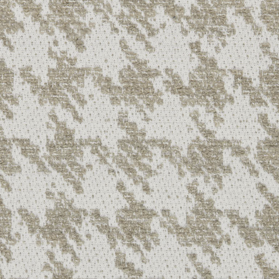 Een close-up van een beige en witte geborduurde stoffentextuur.