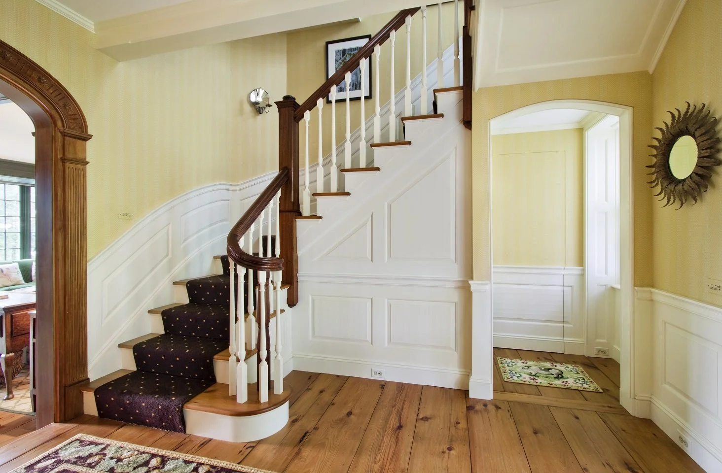 Staircase newel post and arched doorway.jpg