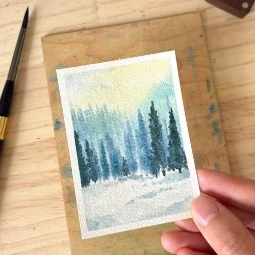tiny watercolor painting of a winter forest landscape
