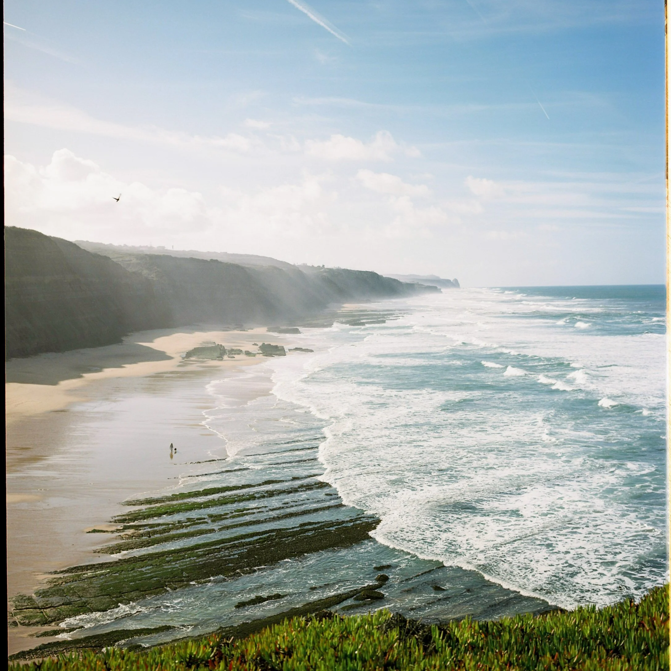 Dog and owner walking on the epic Magoito beach in Portugal shot on 120 film with Mamiya 7ii