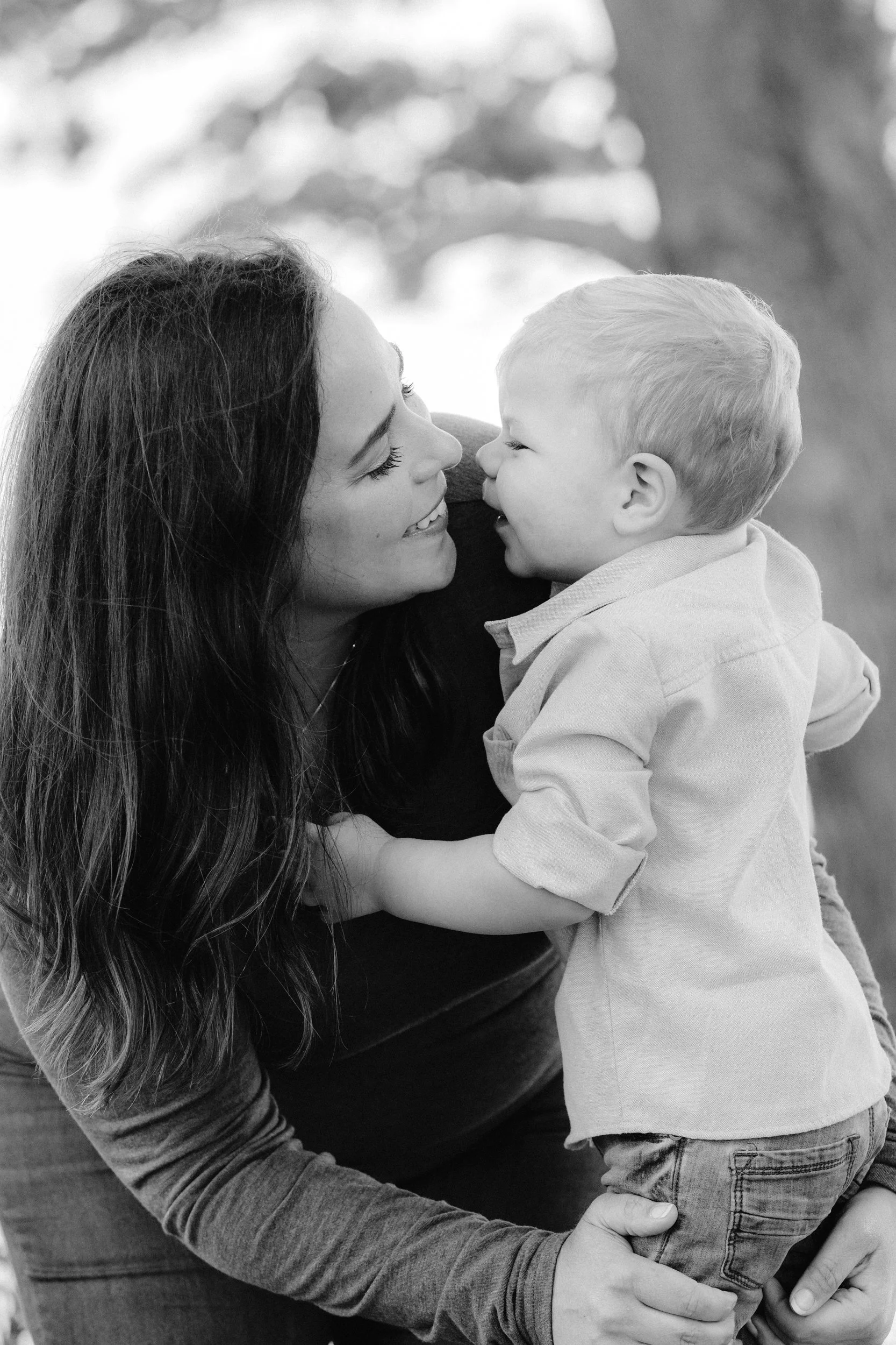  A mother looks at her young son in this black and white candid photo 