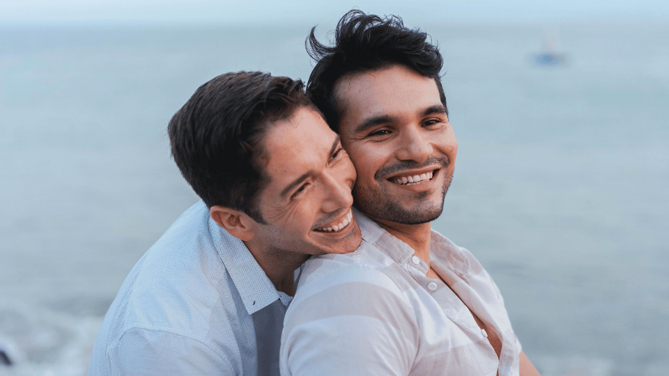 Happy smiling male gay couple by the water for a blog about Donor Egg Treatment in Los Angeles