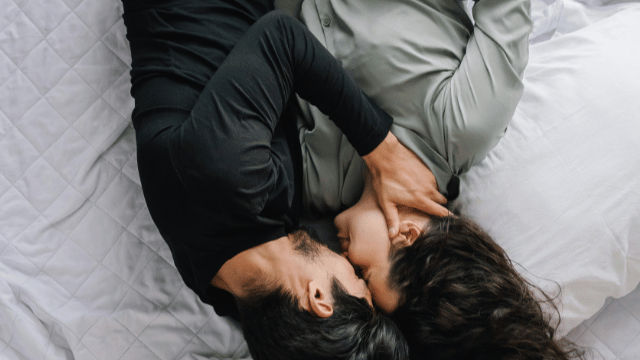 Couple in bed for blog about Debunking Common Myths About Infertility