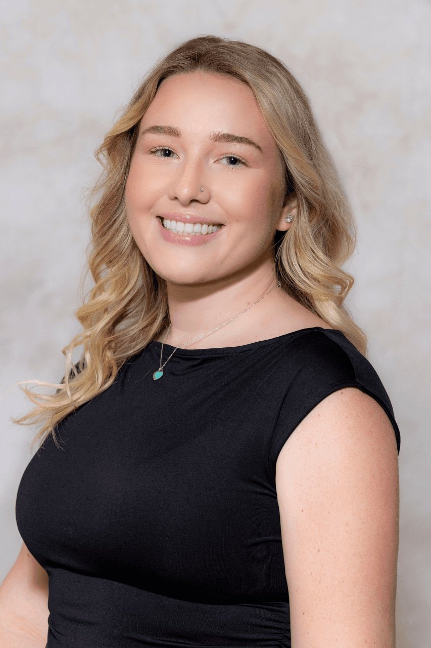 Smiling woman with blonde hair in a black top.