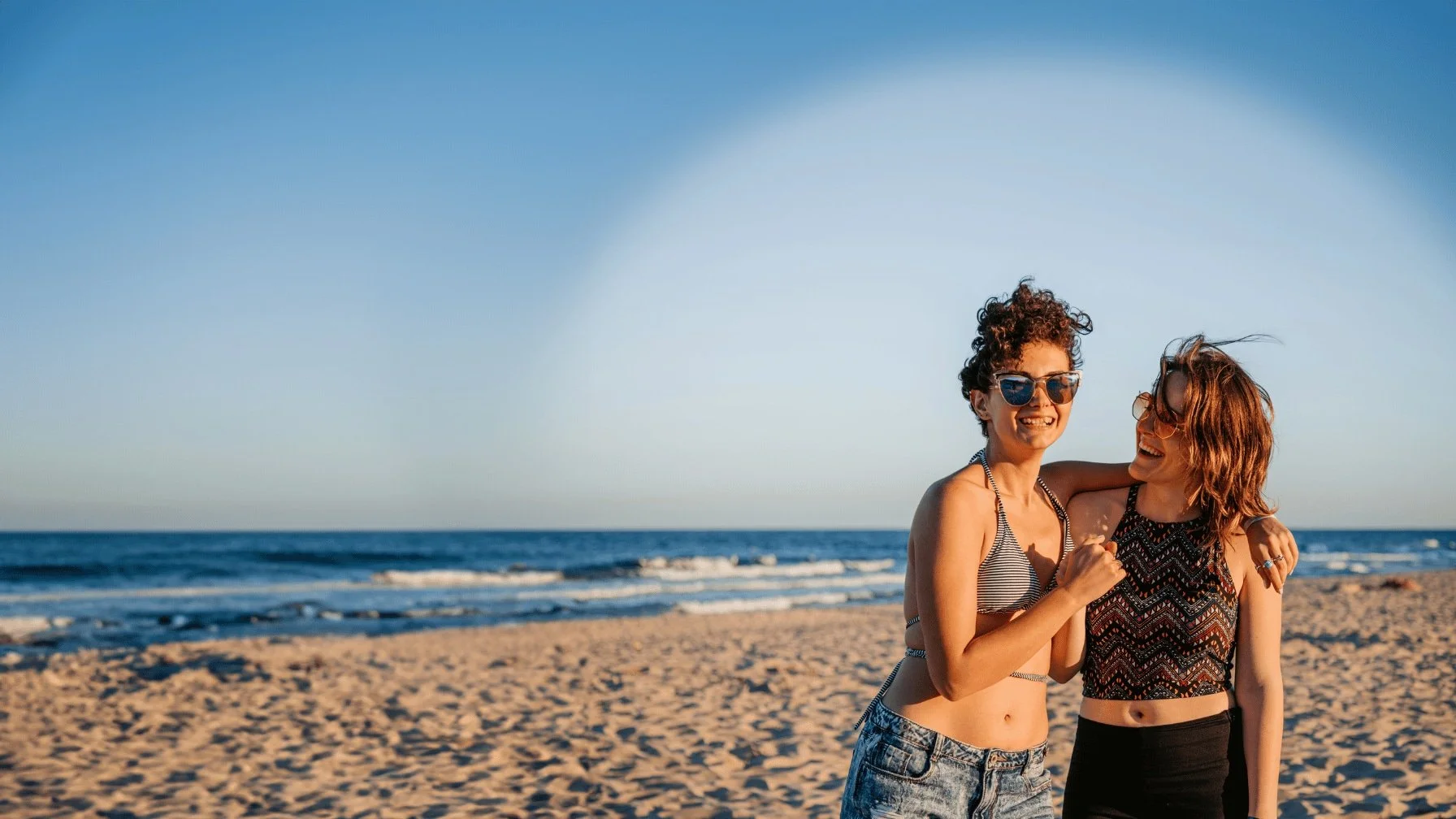 Transgender couple on beach for web page about Transgender Fertility Treatment & Family-Building Services