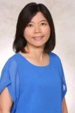 Woman in blue blouse with short dark hair
