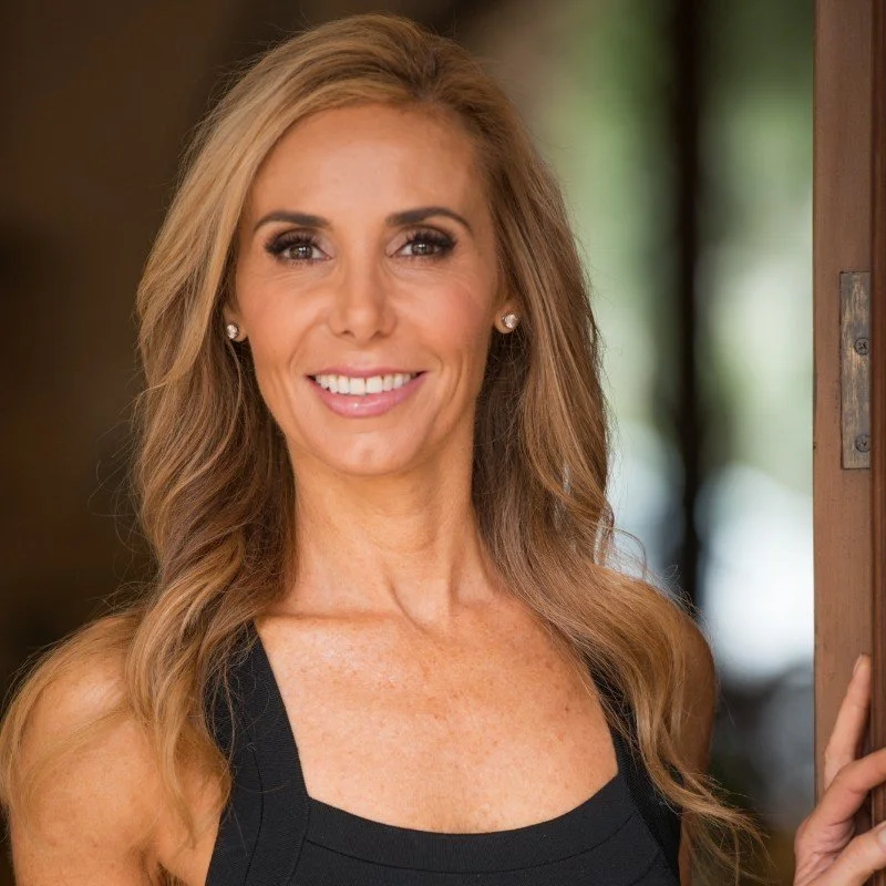 Smiling woman with long hair in a doorway