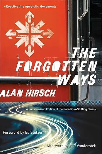 Book cover titled 'The Forgotten Ways' by Alan Hirsch. The cover features a red background with a white snowflake-like symbol and fast-moving light trails at the bottom. The subtitle states it's a revised edition of the paradigm-shifting classic, with a foreword by Ed Stetzer and afterword by Jeff VanderStelt.