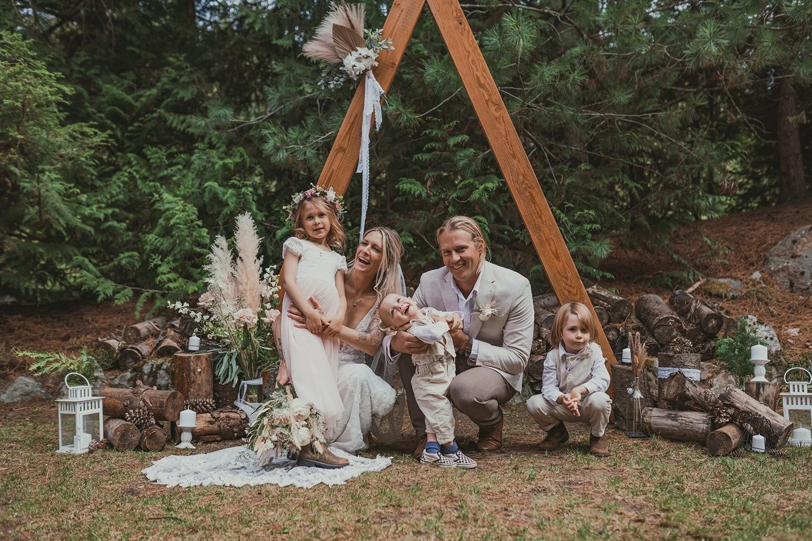 Bride and groom with their children following an outdoor wedding ceremony coordinated by Crest Events in Whistler, British Columbia.