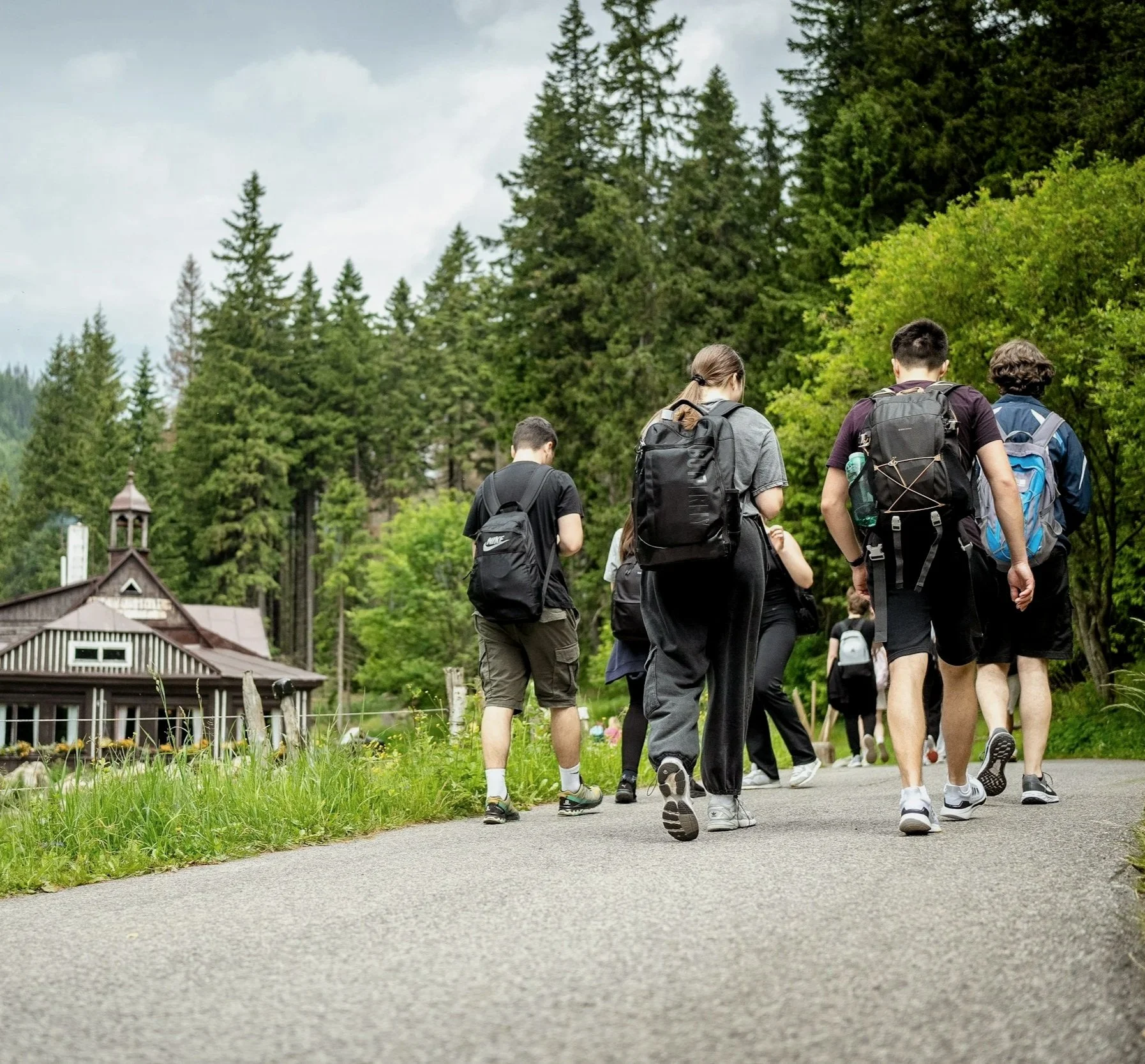 Group walking together at a mountain retreat, representing guest logistics and group coordination.