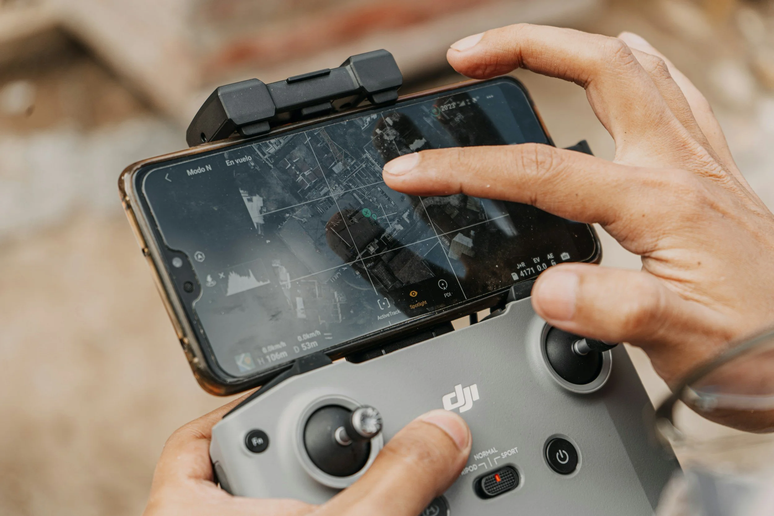 A person holding a drone operation device