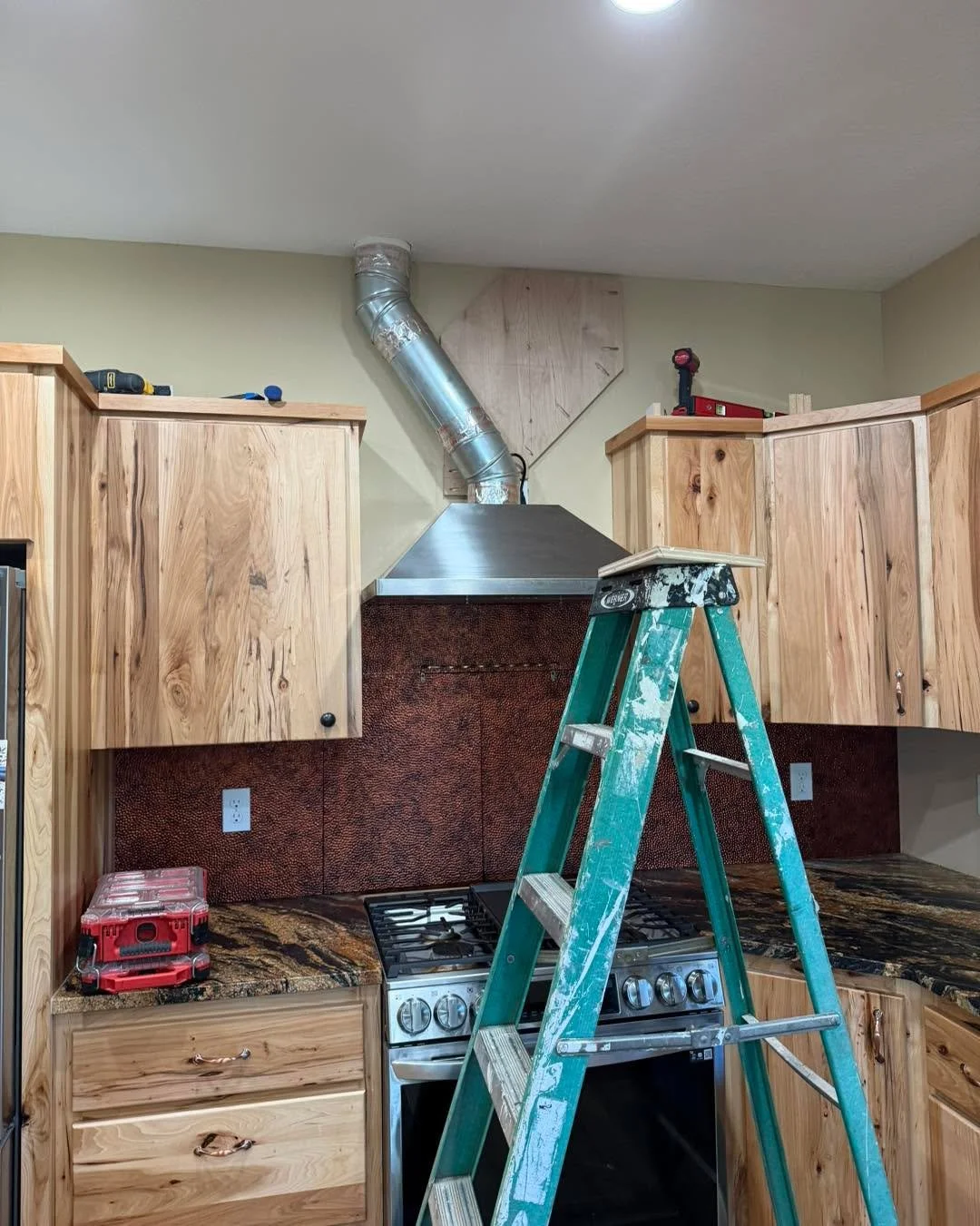 From exposed venting to a finished custom range hood surround, this kitchen now feels complete from top to bottom. Built to match the natural character of the cabinetry, the new wood hood detail adds warmth, structure, and a clean custom finish aroun