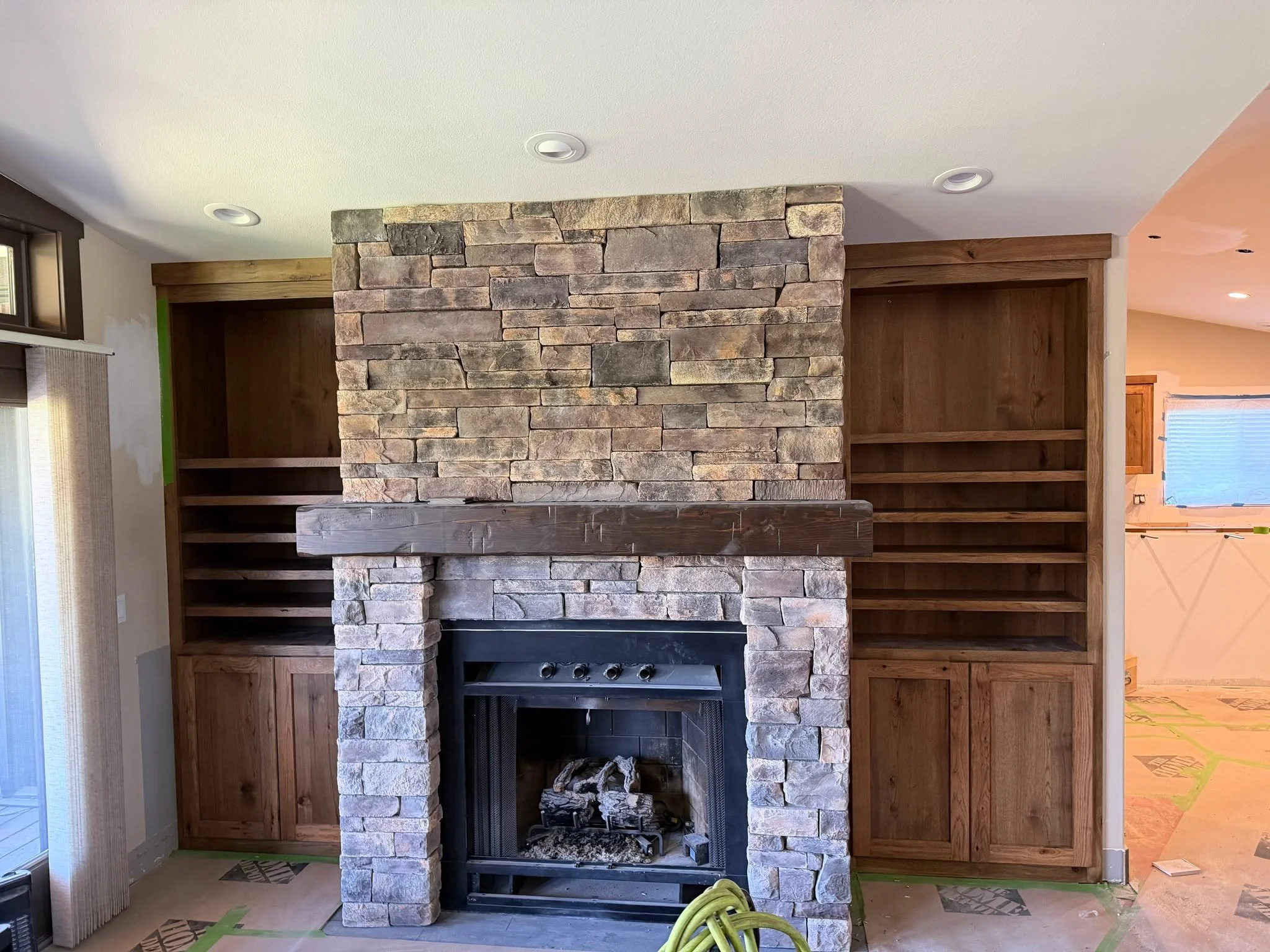 Built to anchor the whole room.
This custom fireplace wall brings together rich wood tones, clean shelving, and rugged stonework for a warm, timeless finish that feels both elevated and inviting.

Thinking about adding custom built ins to your home? 