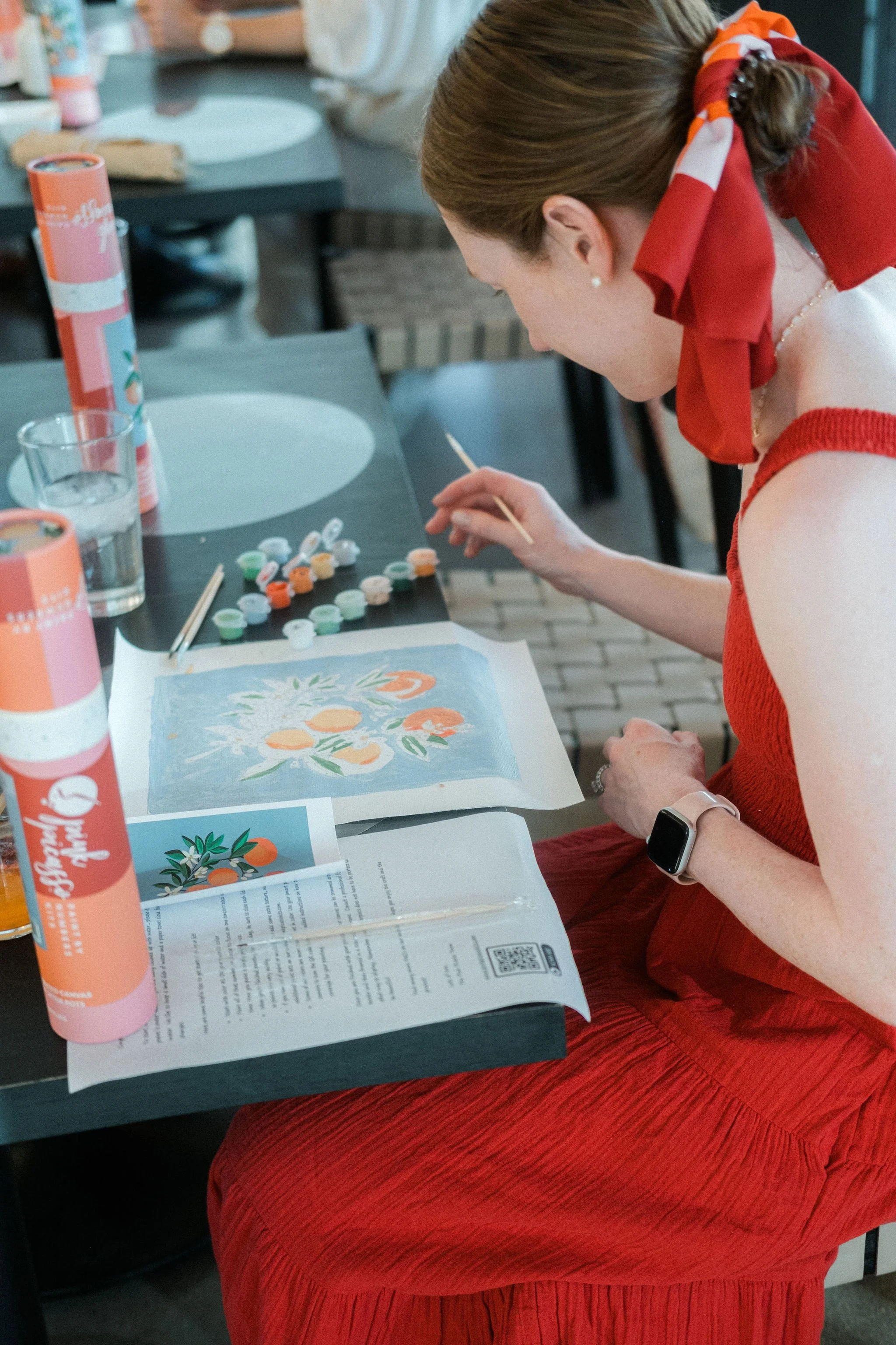 guest interacting and painting a floral design in painting workshop