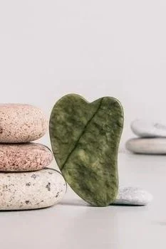 jade-gua-sha-massager-and-pebbles-on-table-web-banner-photo.jpg