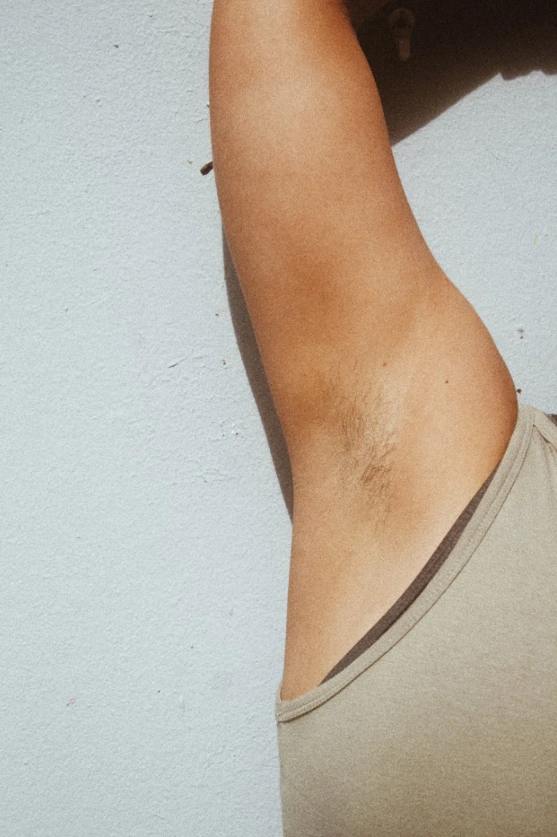 woman's underarm with dark blonde hair before permanent hair removal