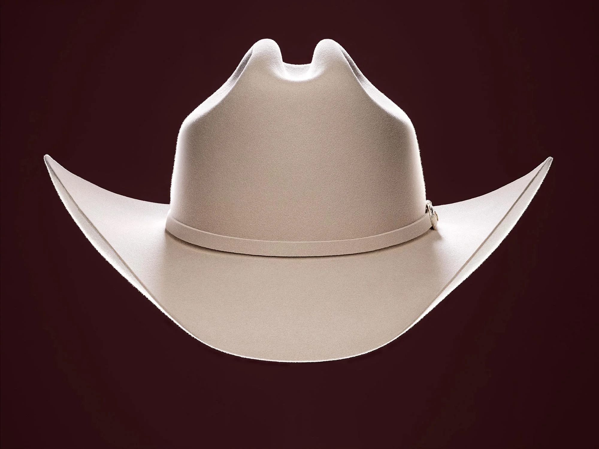 A white cowboy hat against a dark background.