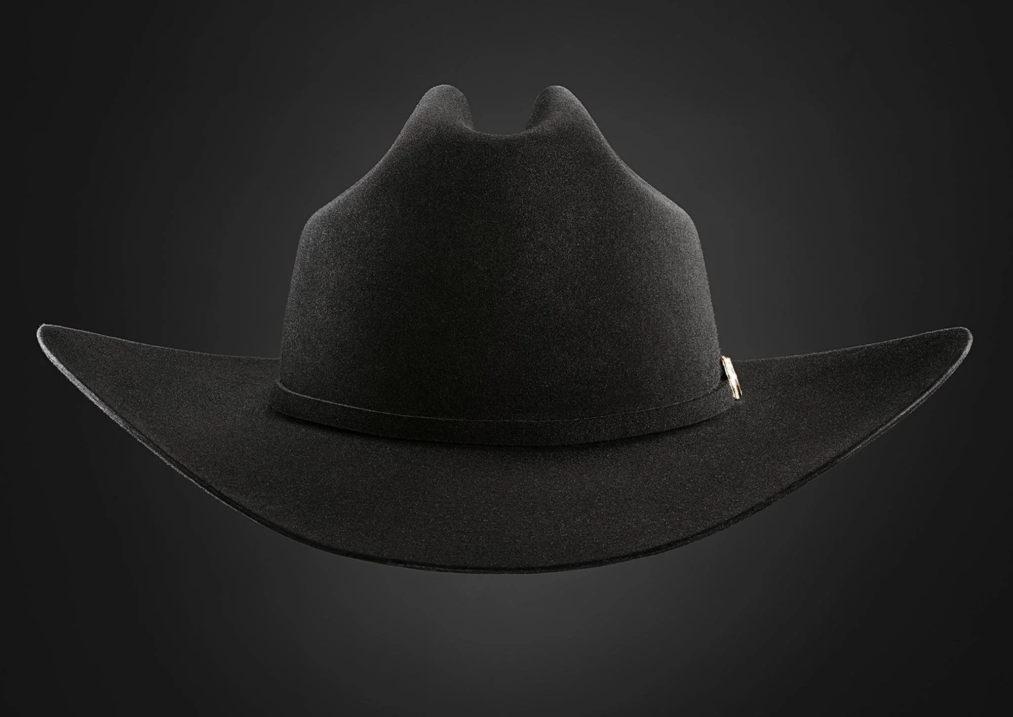 Black cowboy hat with a wide brim displayed against a dark background.
