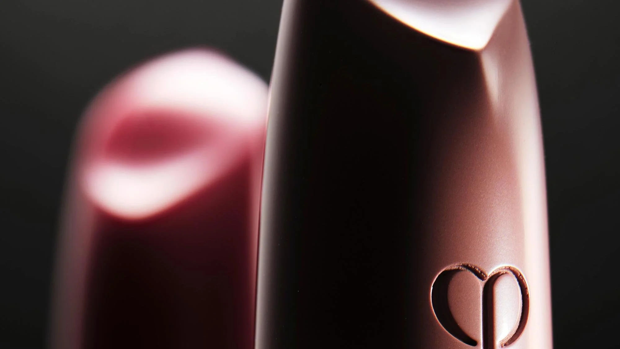 Close-up cosmetic product photography emphasizing form and lighting.