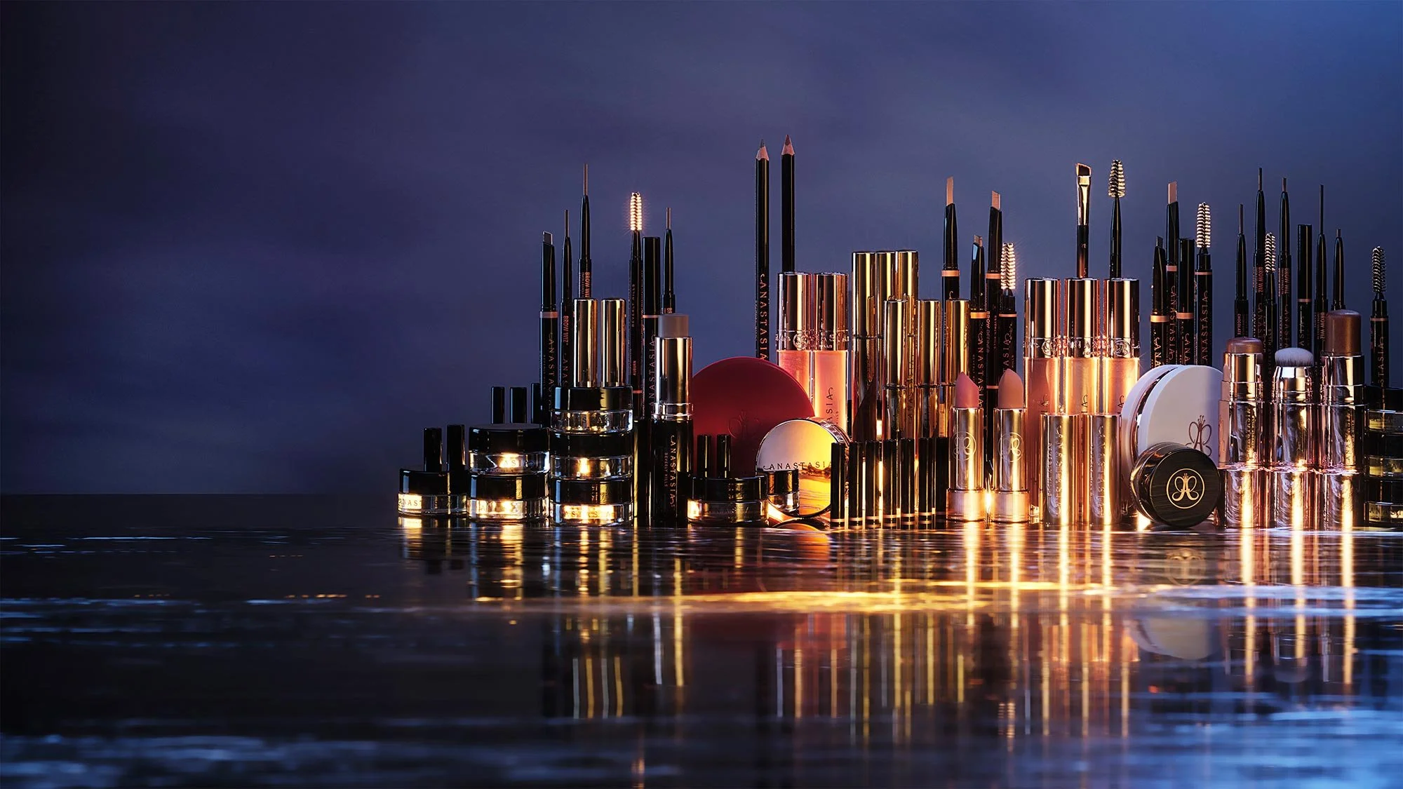 Collection of luxury makeup products including lipsticks, eyeliners, and compacts with a reflective surface and dark blue background.