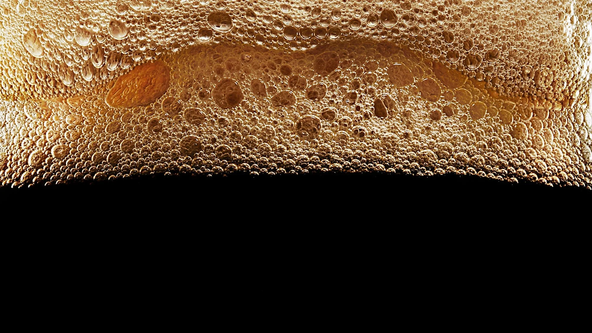 Still life beverage photography focusing on foam texture and lighting.