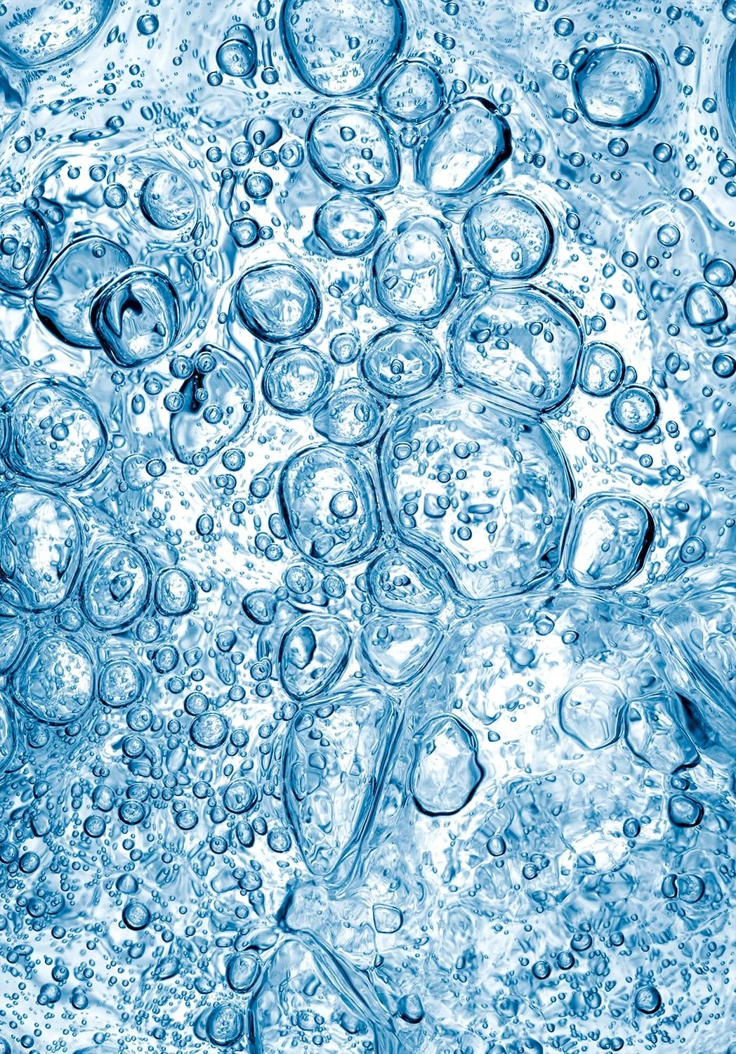 Close-up of bubbling carbonated water with many bubbles forming on the surface.