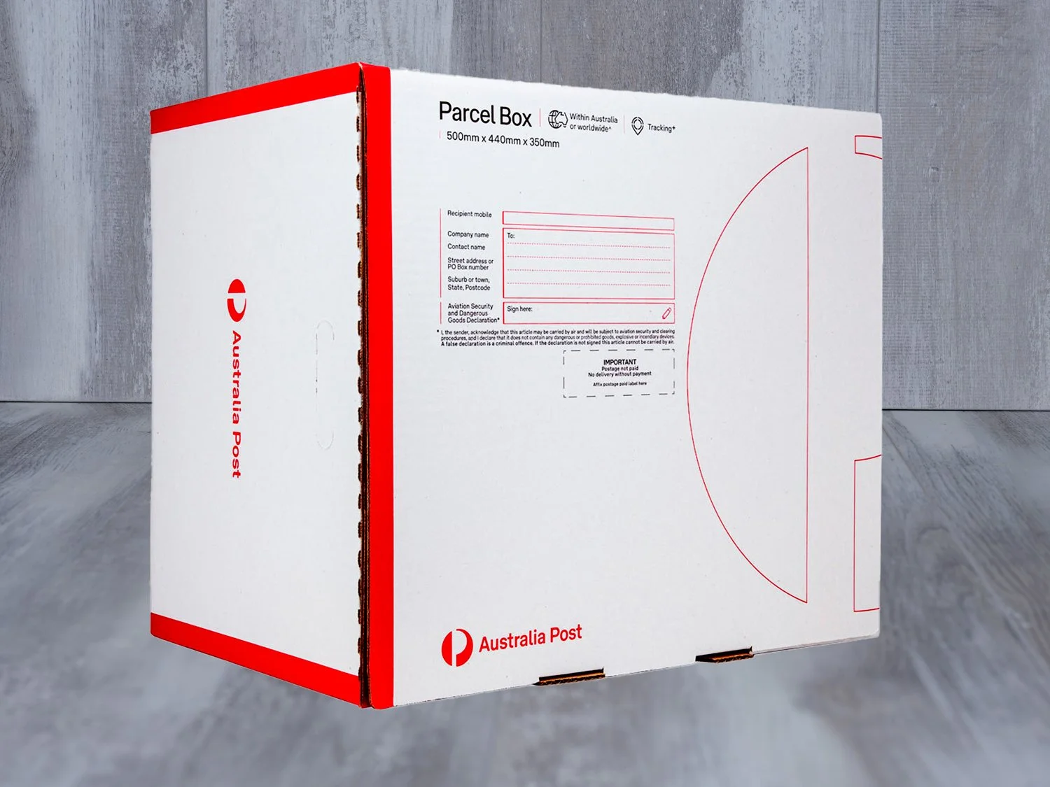 White parcel box with red accents, labeled 'Australia Post' and 'Parcel Box', standing on a concrete floor against wooden panel background.