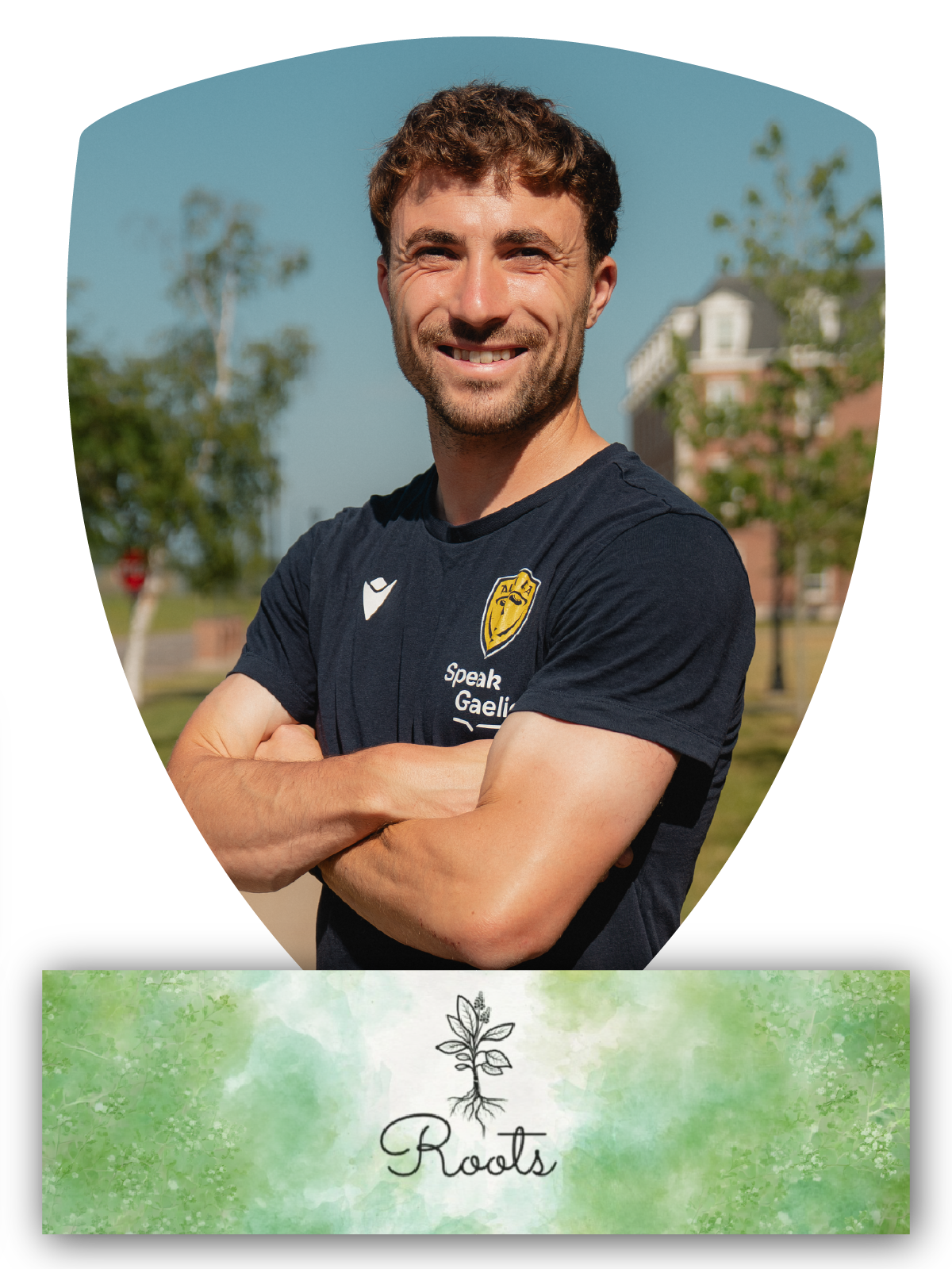 A young man in a dark sports uniform with yellow accents, standing with his hands behind his back against a dark blue background with a mountain landscape. The uniform displays the number 2 and a badge of Alba FC, with the name Daniel Moran and the number 2 in a yellow box at the bottom.
