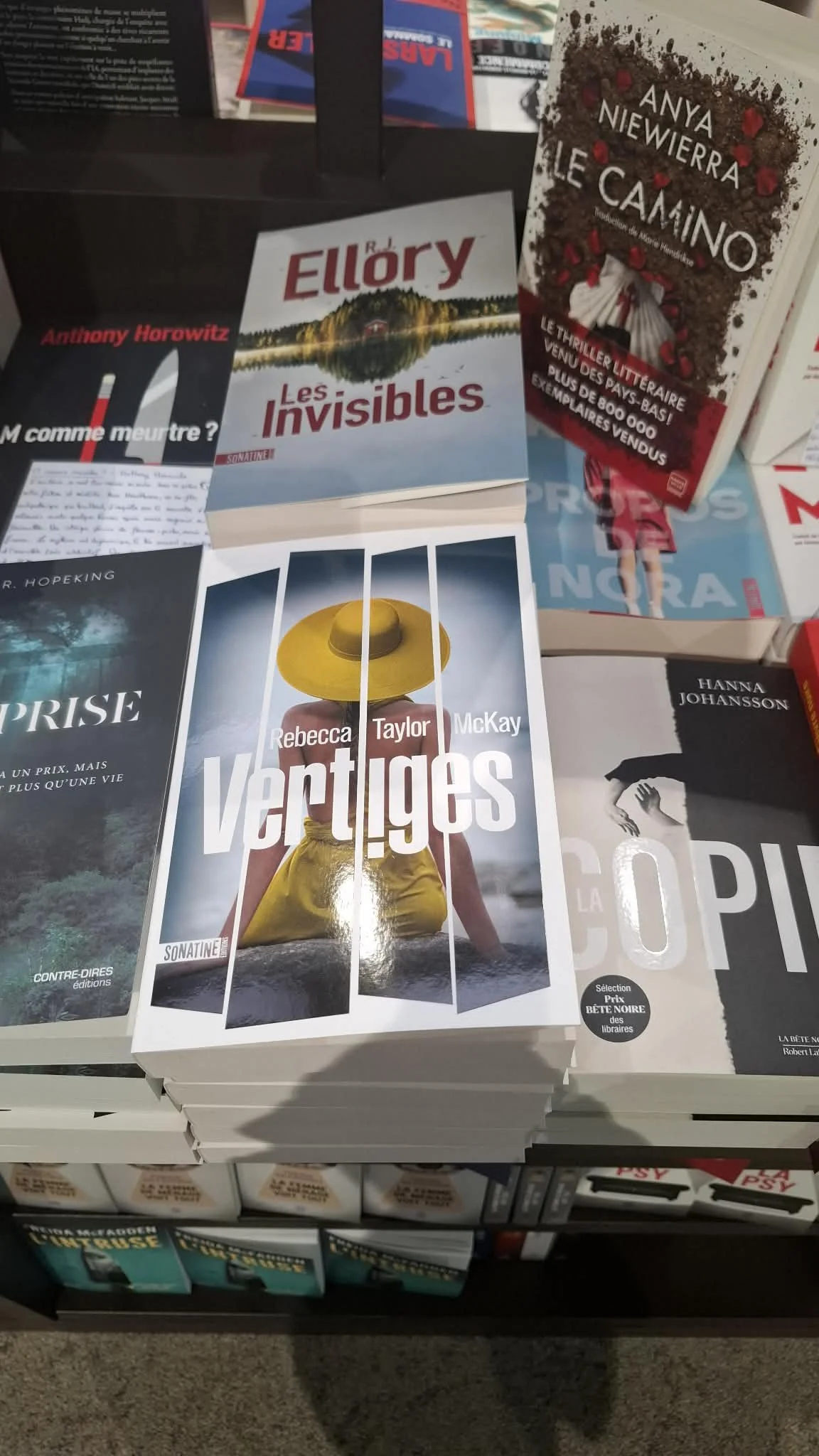 the image shows a display table in a bookshop with Vertiges by Rebecca Taylor McKay front and centre