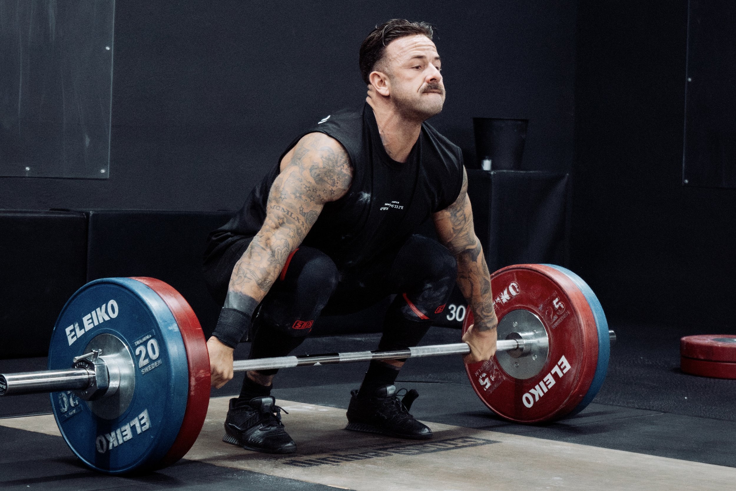 Athlete performs a barbell snatch with eleiko bar and plates